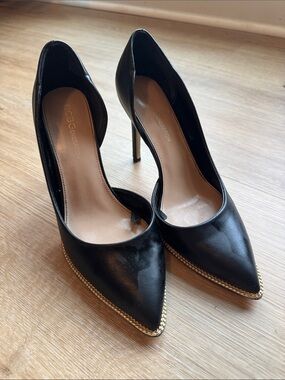 BCBGeneration Black Pointed Toe Pumps with Gold Chain Trim
